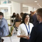 Delegates Networking During Coffee Break At Conference